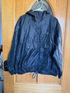 Izod black windbreaker jacket with hood and drawstring waist. Size L